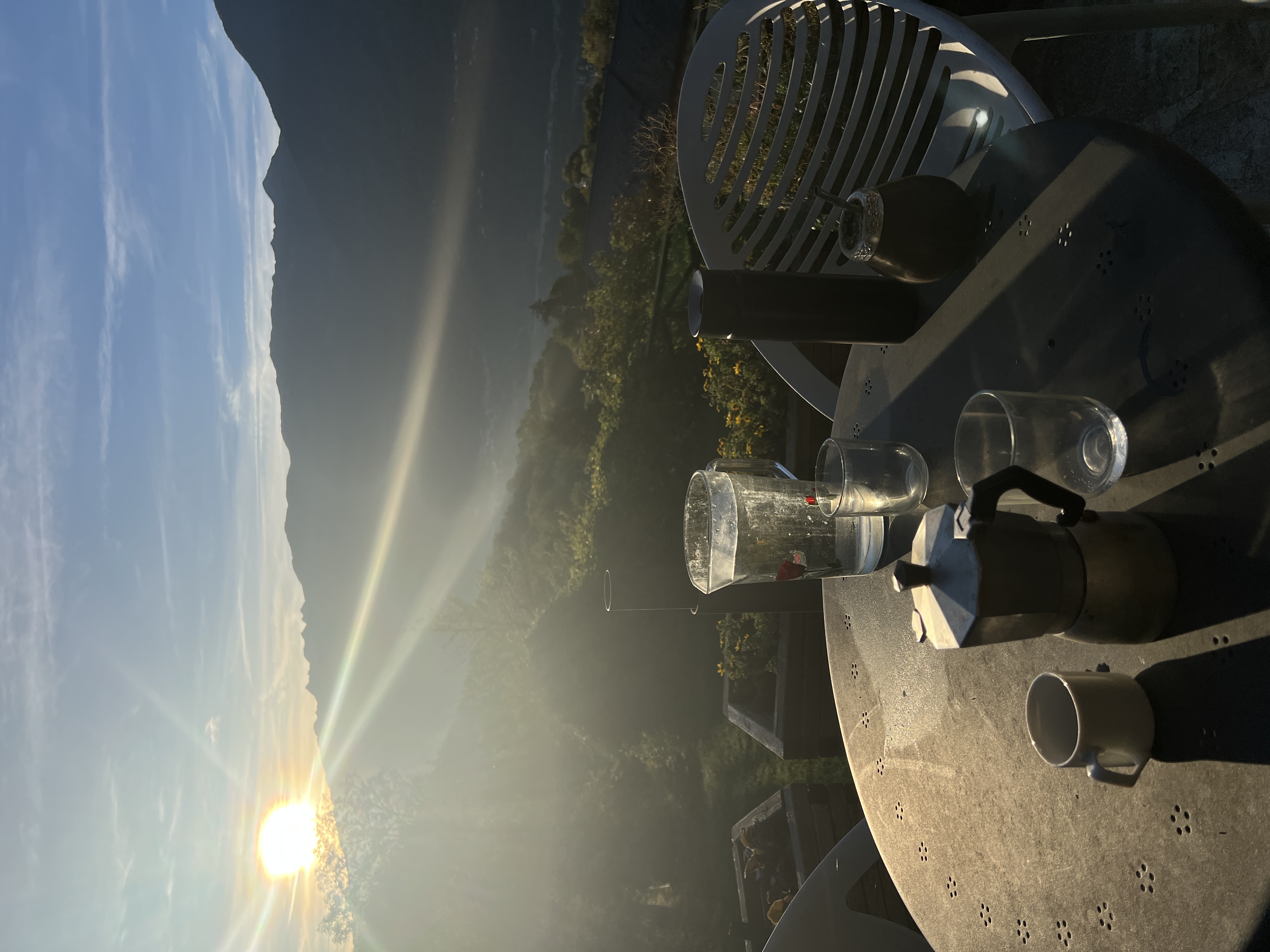 Coffee and mate on a terrace overlooking the mountains at sunrise.